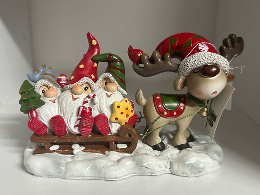 Reindeer pulling a sled with gnomes