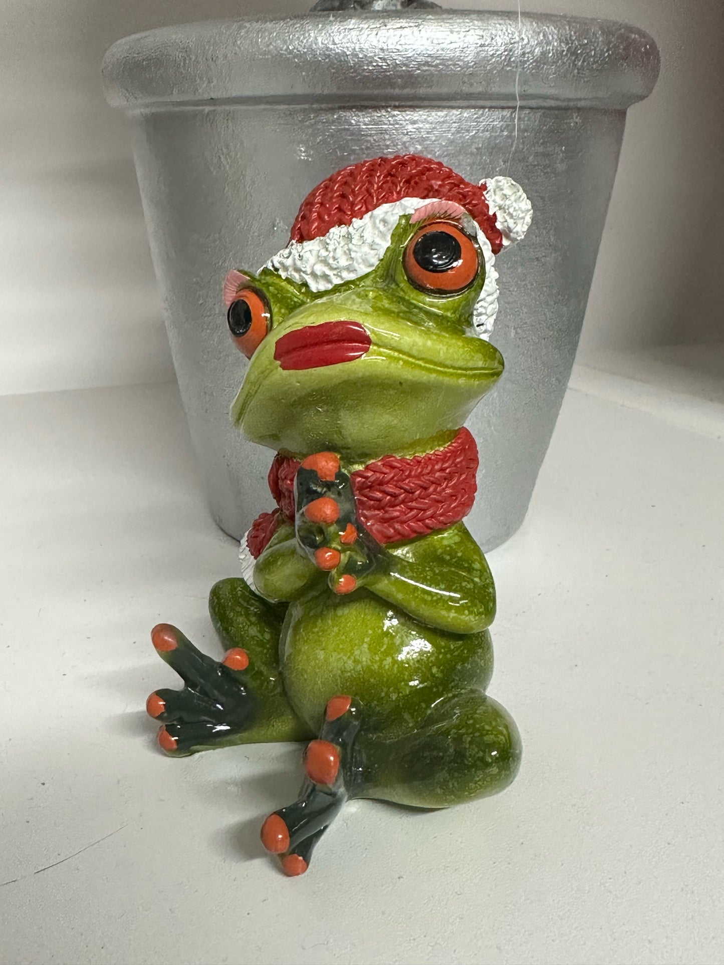 Christmas Frog clutching hands