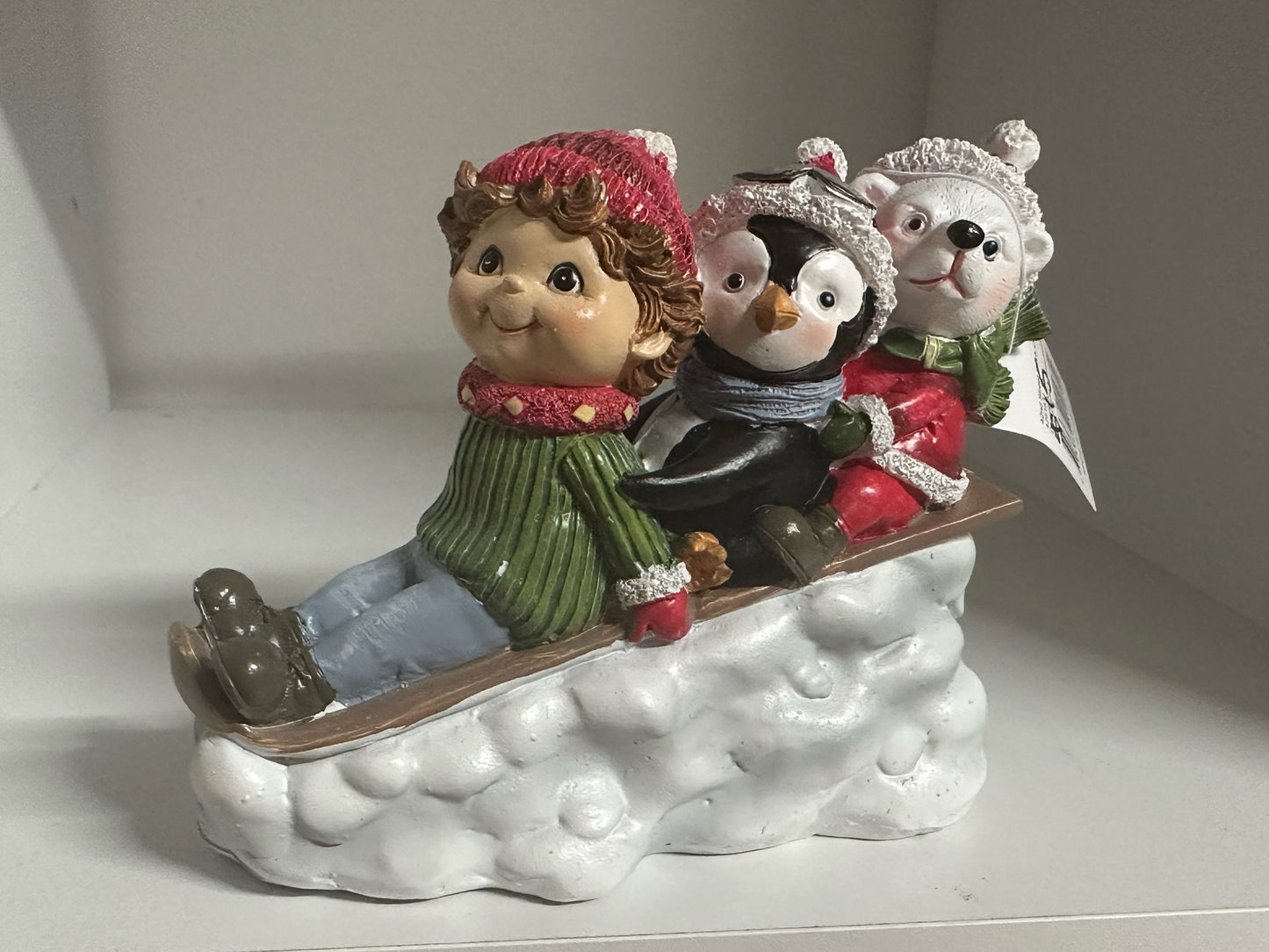 Child, Penguin and Bear in sled